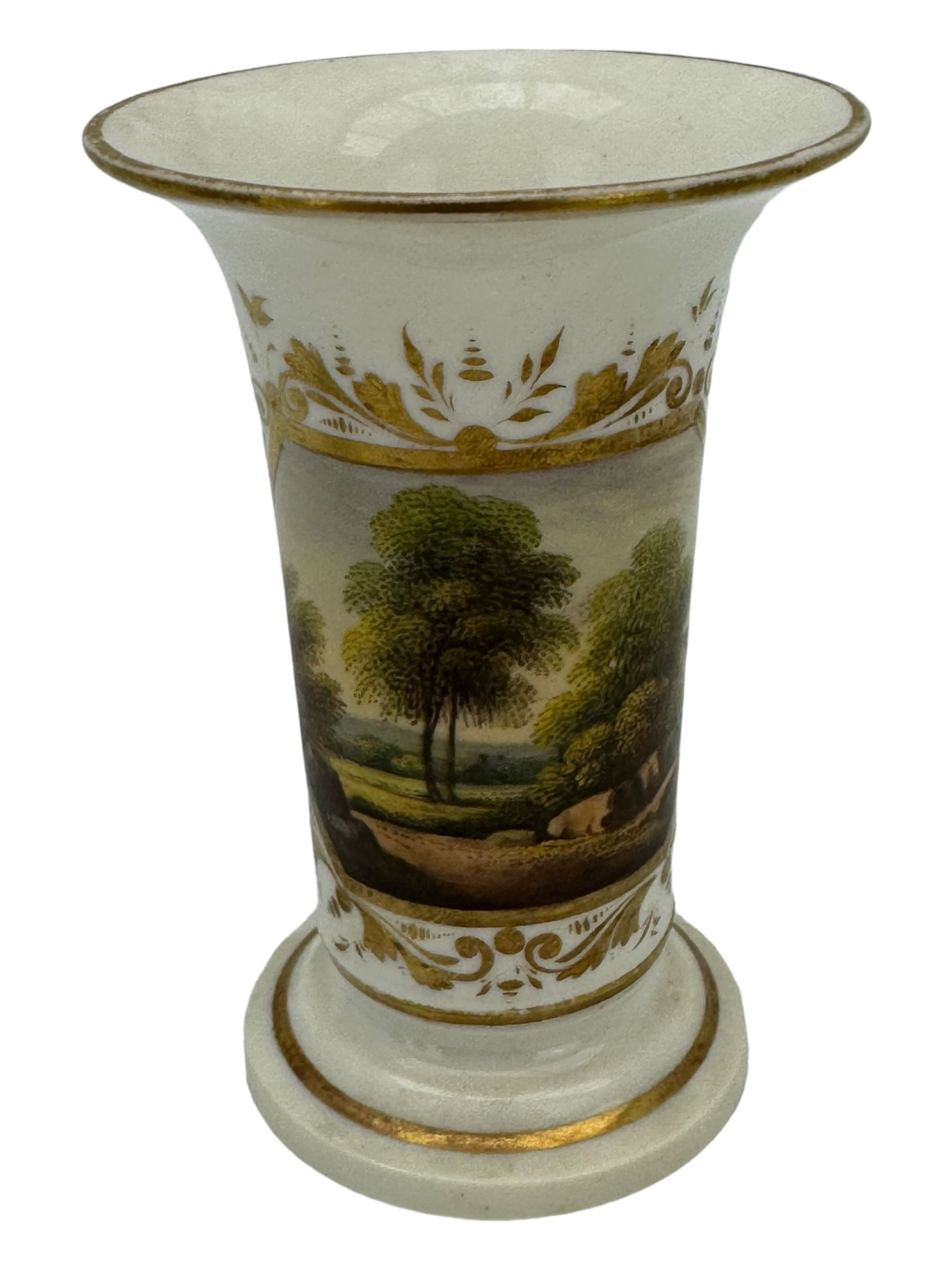 Early 19th century Derby porcelain to include a campana form inkwell, small bottle form vase, twin handled vase and flared rim vase, hand painted with a landscape scene, H10cm (4)