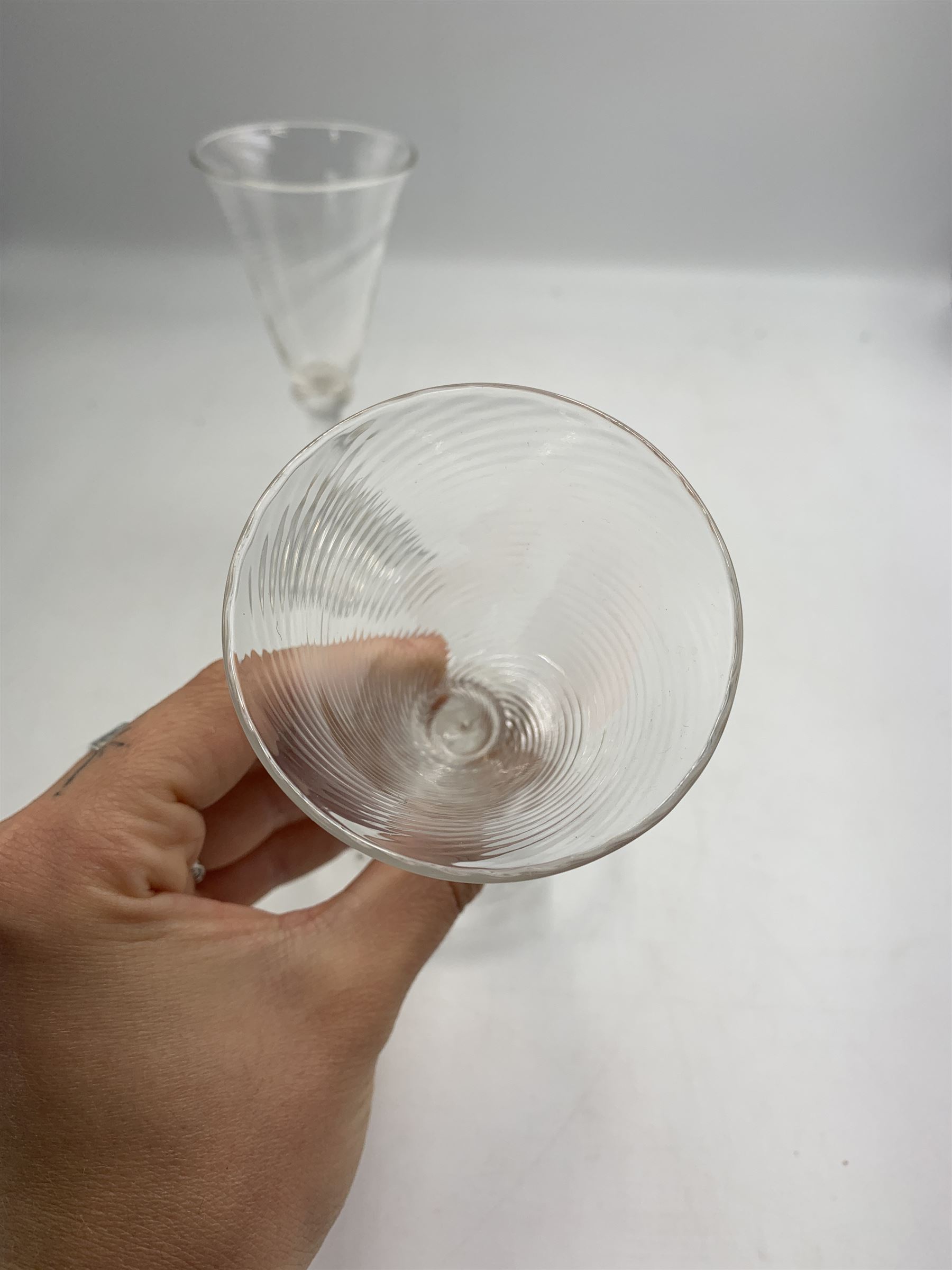 Pair of 18th century Liege wine glasses, circa 1730, with wrythen fluted trumpet bowls and knopped stems, H14.5cm