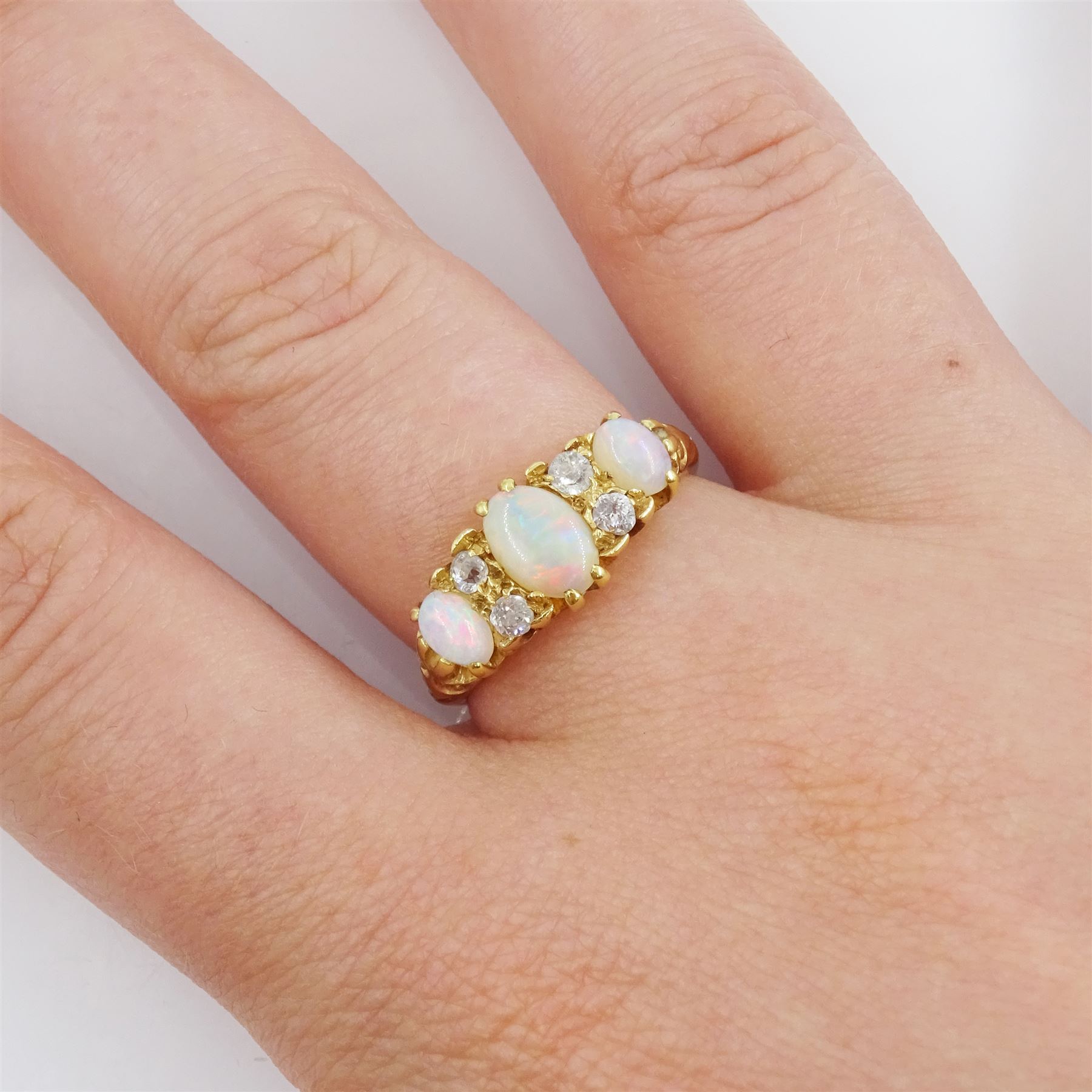 Early 20th century 18ct gold three stone opal and four stone old cut diamond ring, hallmarked