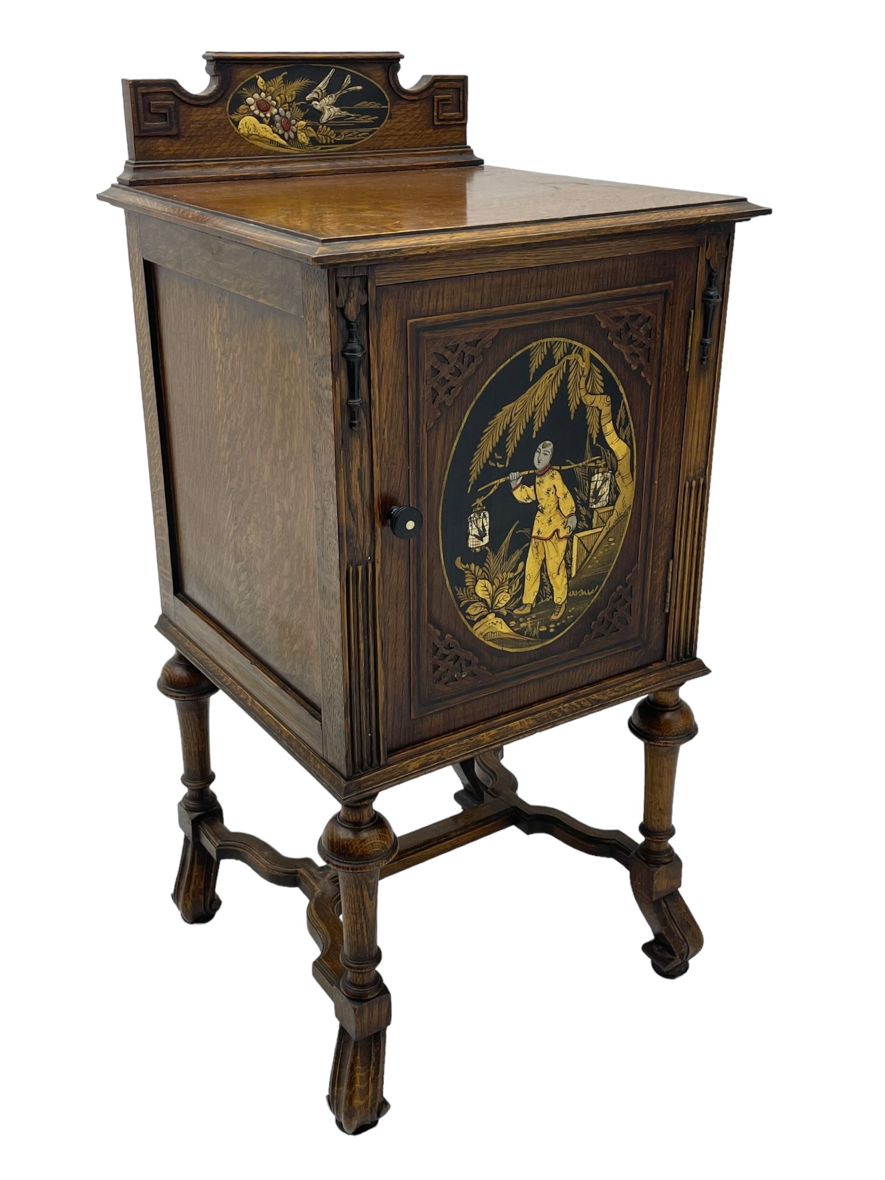 Early 20th century circa. 1920s oak bedside cupboard, raised back decorated with chinoiserie lacquer work depicting bird and flowers, moulded top over single door decorated with figure carrying bird cages, on turned supports united by shaped moulded stretchers, scroll carved feet