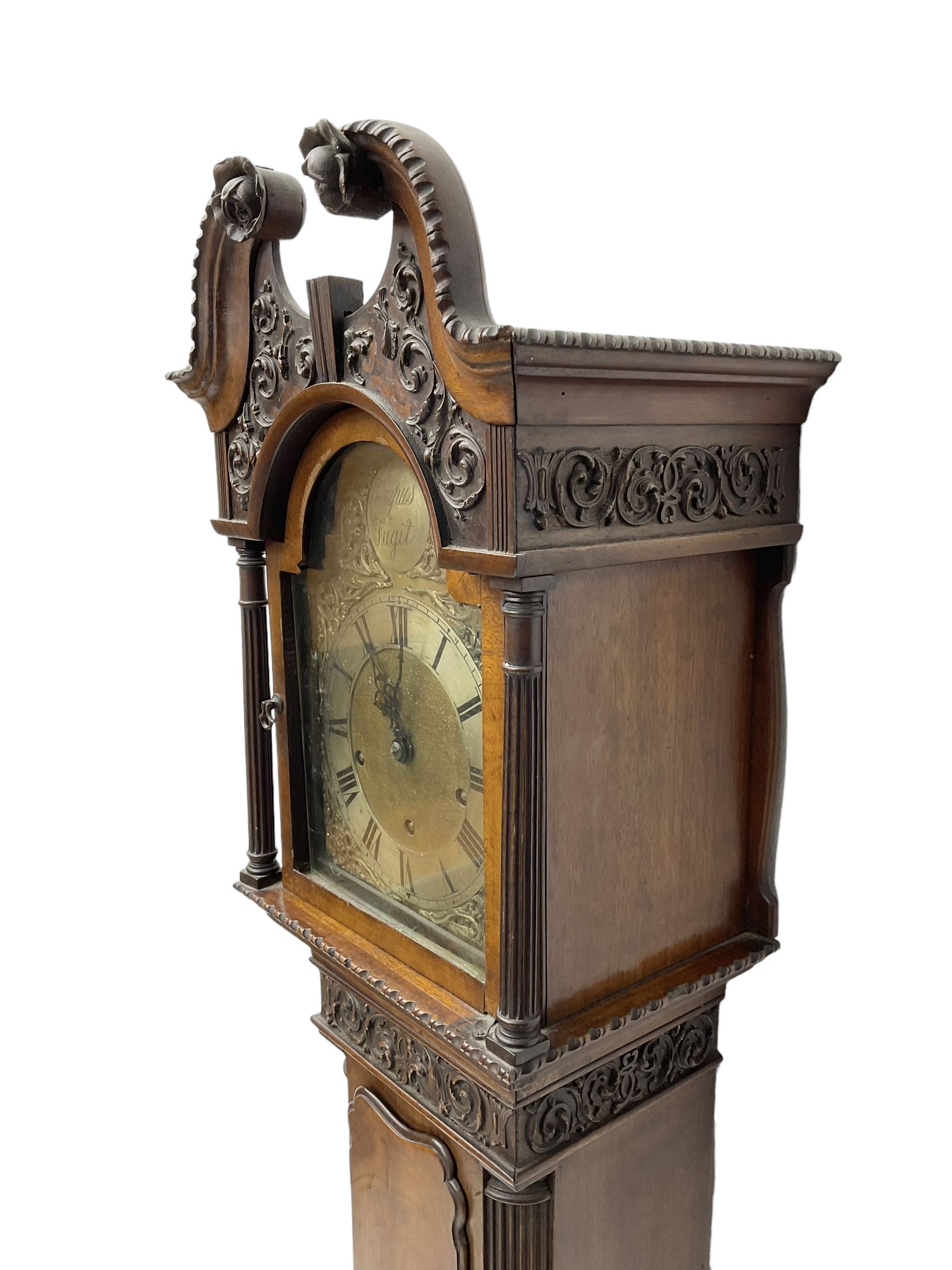 20th century - Chippendale design mahogany 8-day Grandmother clock with a profusely carved and decorated swan's' neck pediment, break arch hood door flanked by reeded pilasters with wooden capitals, trunk with a carved frieze, canted corners, three quarter reeded pilasters and a long trunk door with a wavy top, plinth with carved brickwork to the corners and raised on a shaped base, brass dial with a plain centre, cast spandrels and a silvered 