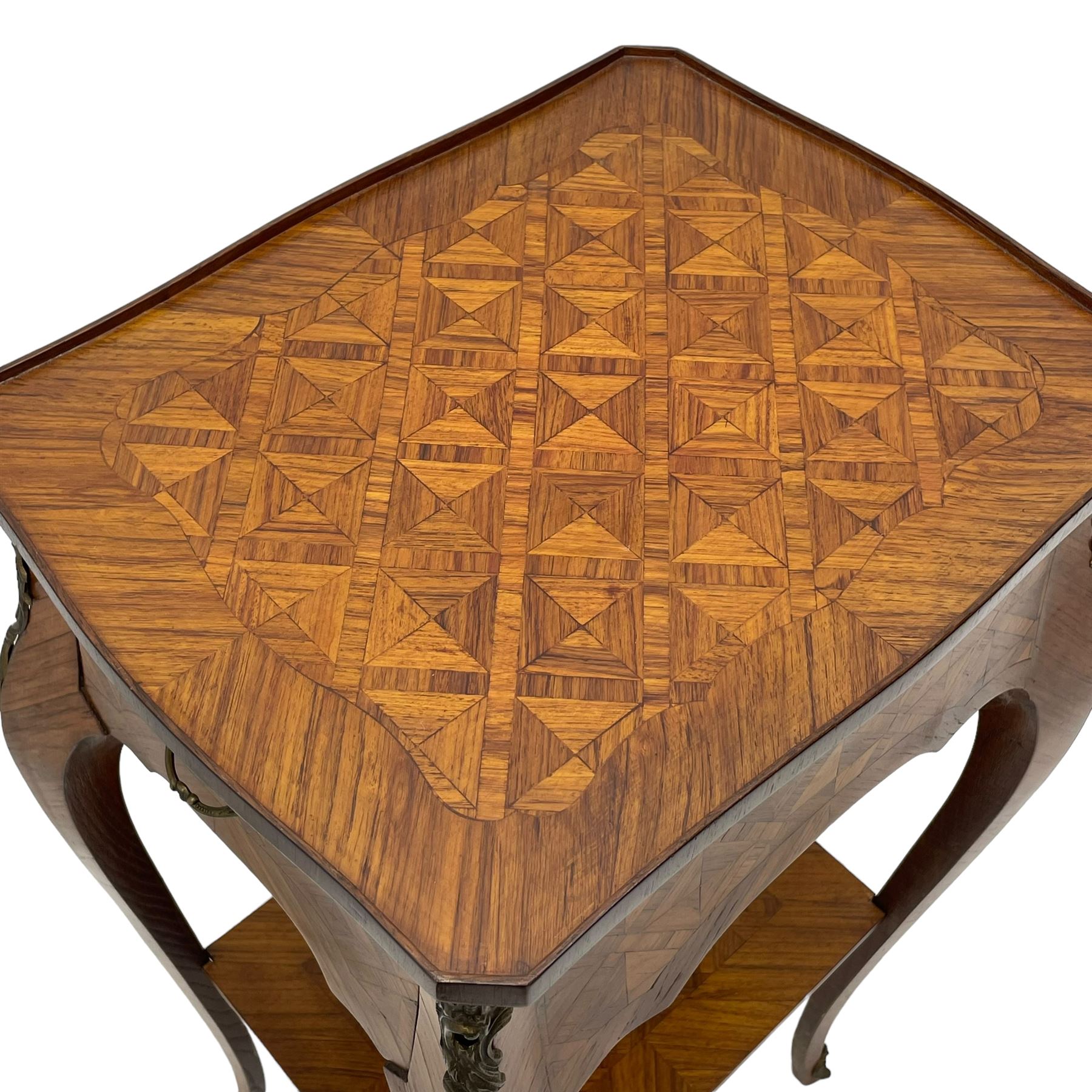 Late 20th century French design Kingwood lamp table, shaped form with geometric parquetry inlaid top within band and raised lip, fitted with single drawer and slide, on cabriole supports united by undertier, decorated with ornate cast gilt metal mounts and terminal caps 