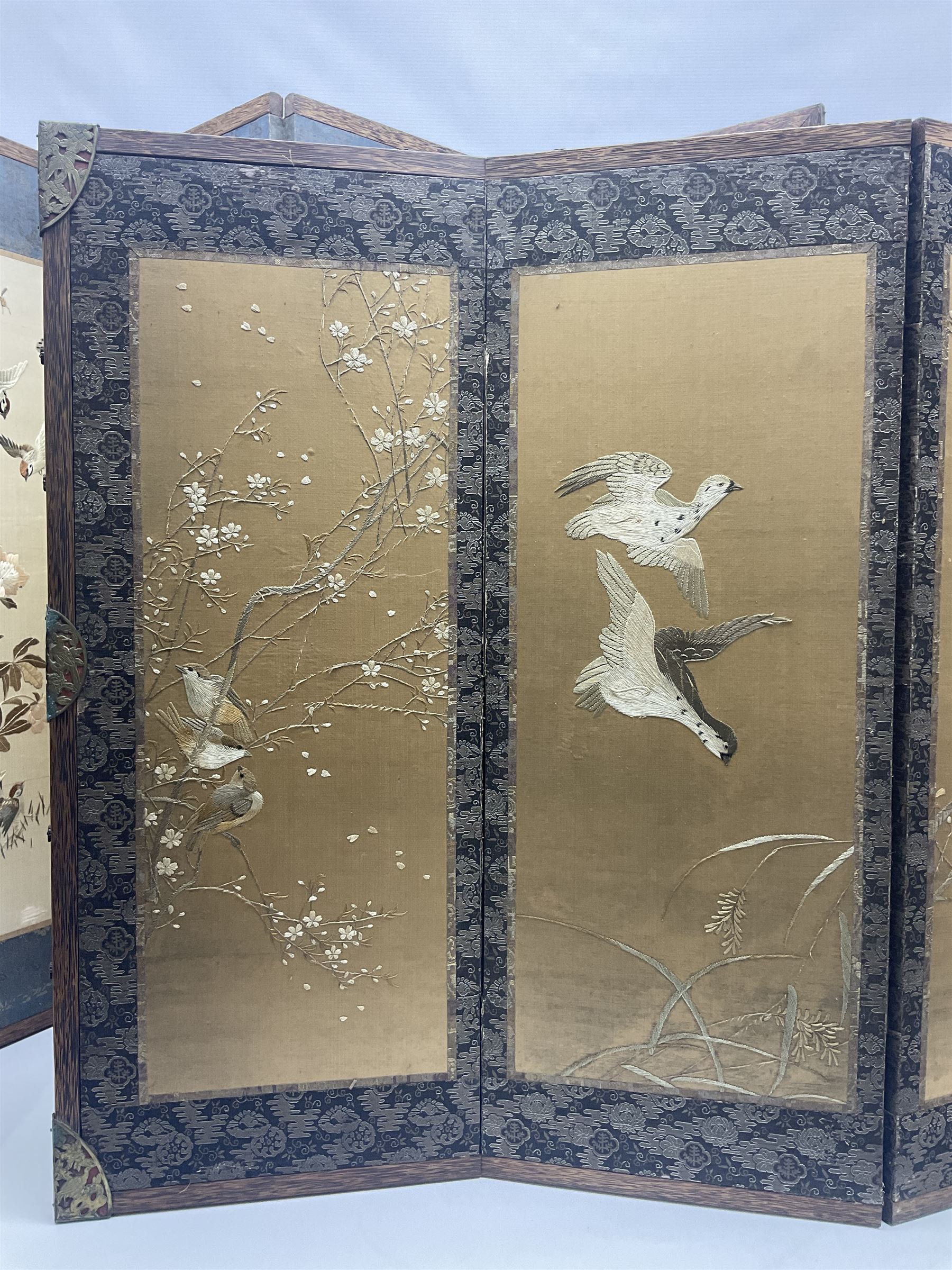 Two Oriental silk and wooden screens embroidered with birds and blossoming branches, largest H88cm 