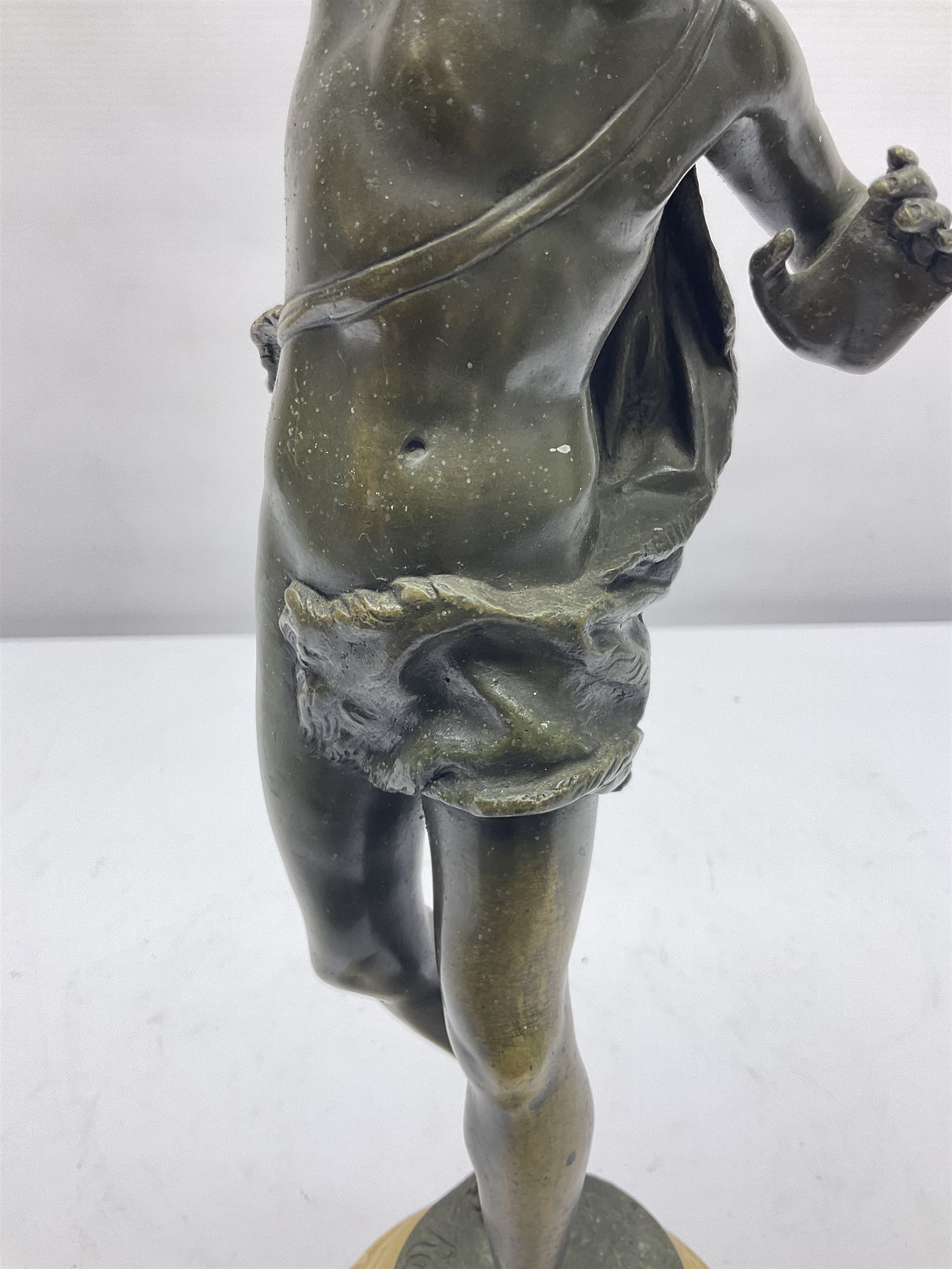 After Ernest Rancoulet, bronzed figure modelled as a man playing the tambourine, upon a stepped circular base, H37cm 