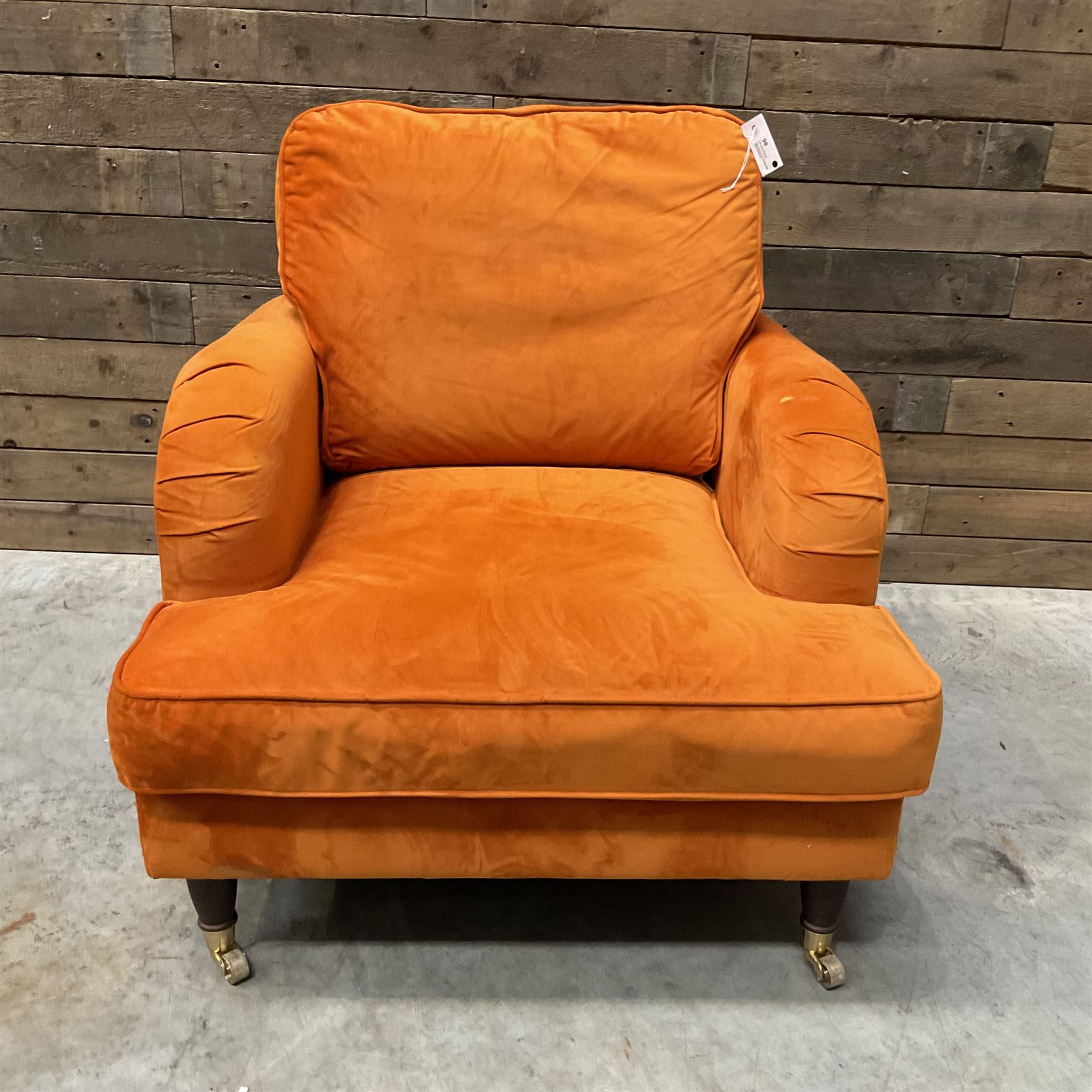 Armchair upholstered in orange velvet fabric