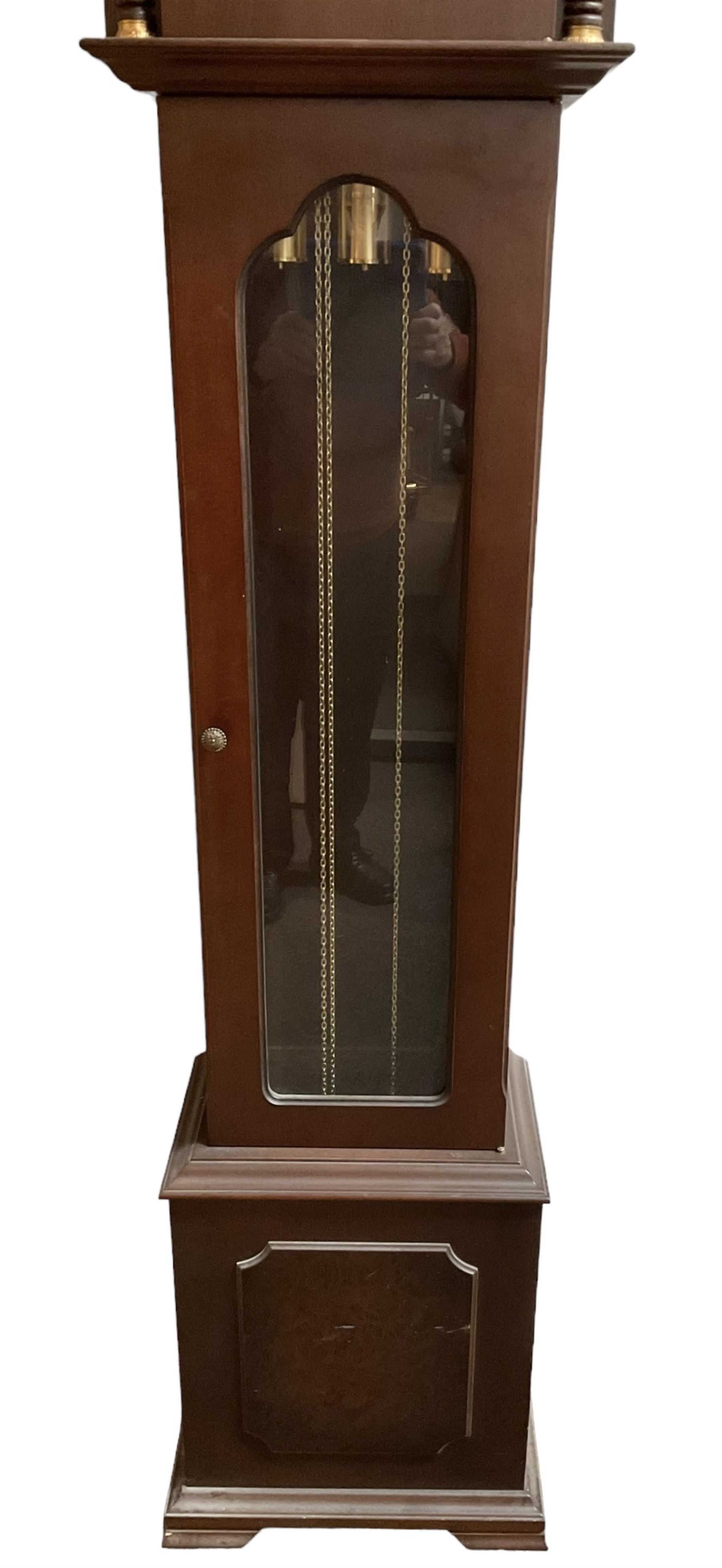 20th century - 8-day Mahogany longcase clock, with a swans necked pediment and break arch hood door beneath,  glazed door with visible brass cased weights and pendulum, on a rectangular plinth with a raised panel and bracket feet, brass dial with a silvered dial centre and chapter ring, chain driven three train movement chiming the quarters and hours on gong rods. With weights and pendulum.  