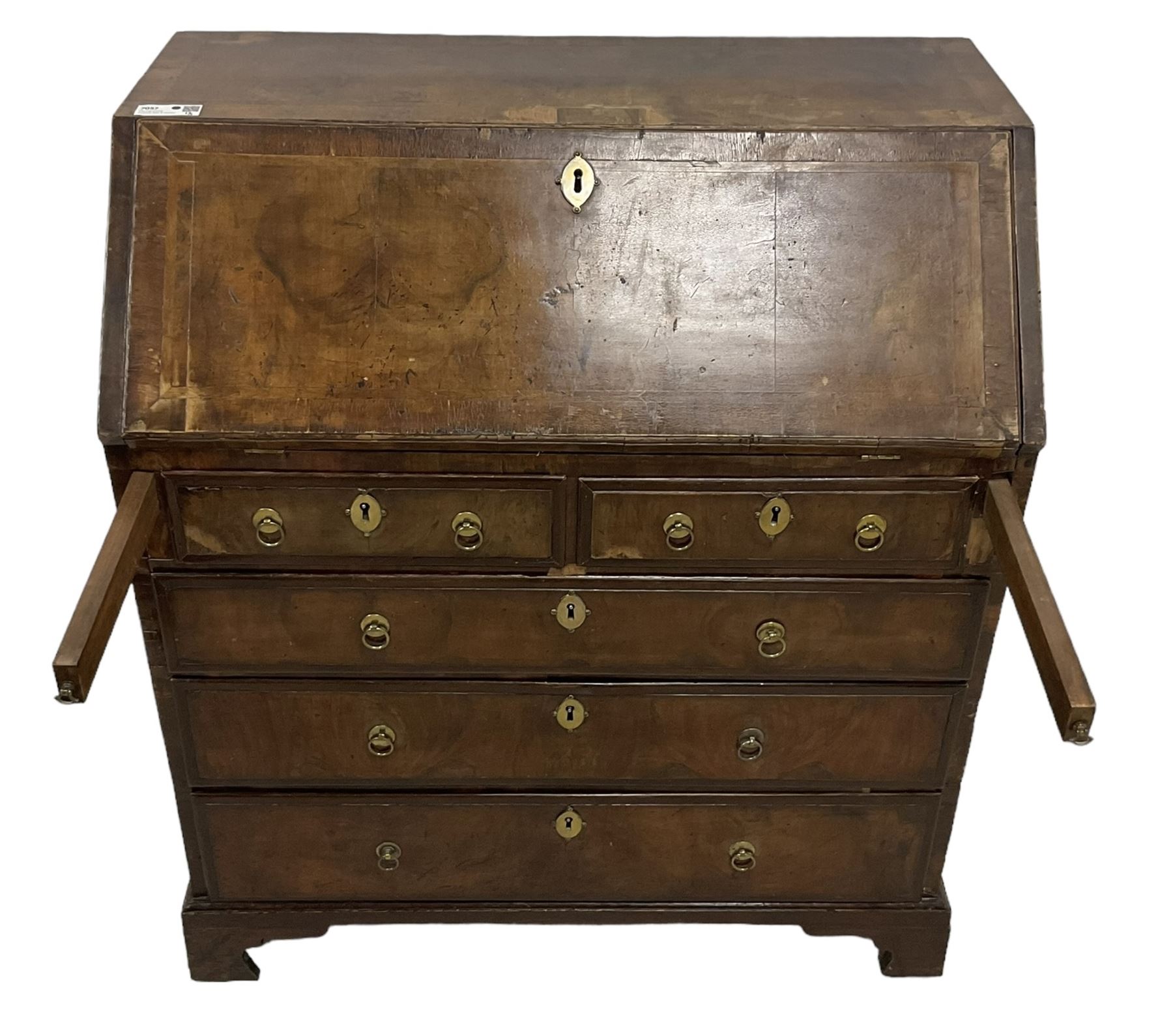 18th century walnut bureau, crossbanded and feather-banded rectangular top and fall-front, enclosing fitted interior with pigeonholes and correspondence drawers with bone handles, over two short and three long graduating drawers with moulded facias and original brass handles, on bracket feet