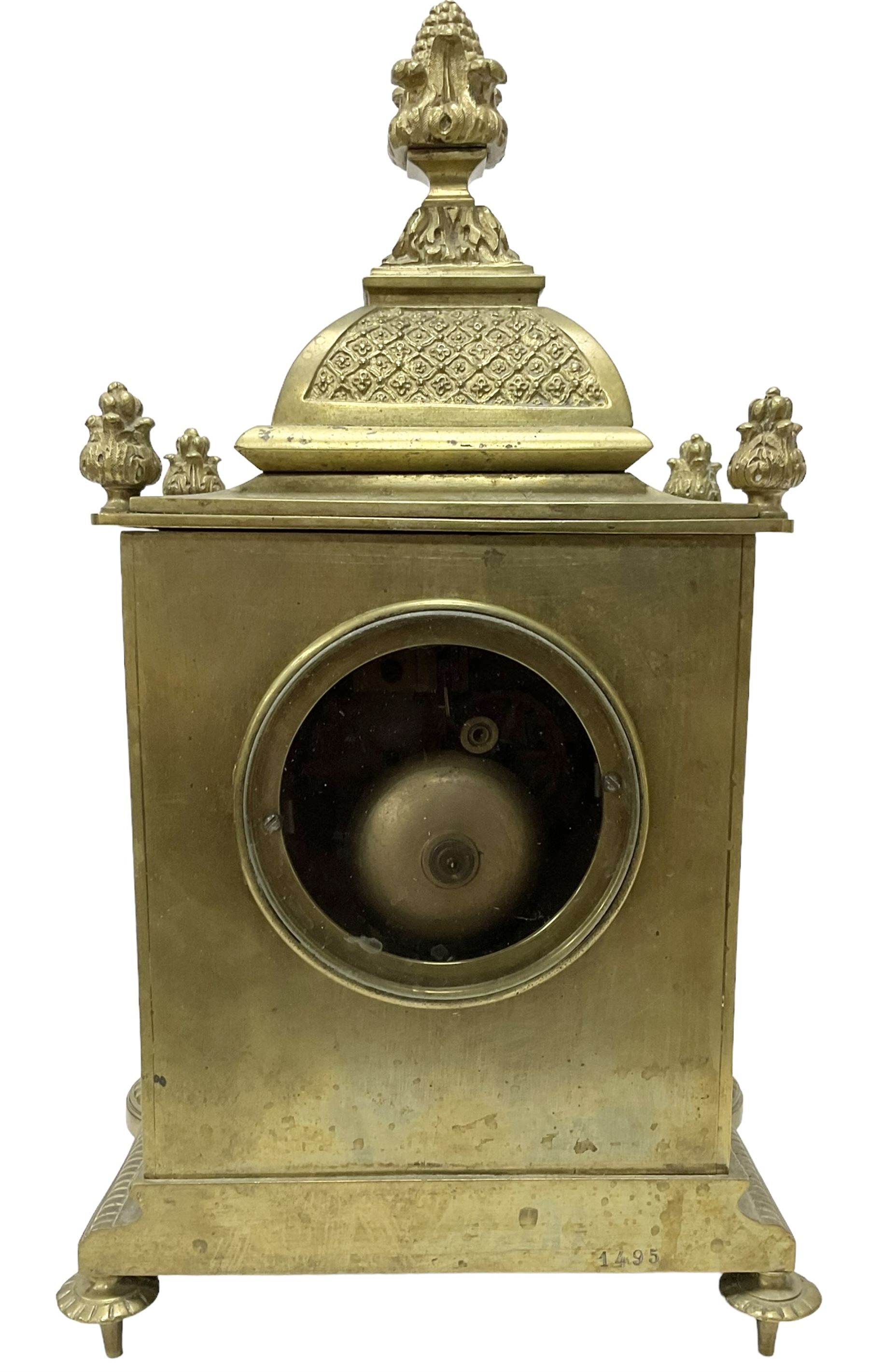 French - Brass cased 8-day mantle clock c1880, with a domed top surmounted by a pineapple finial, four reeded pilasters to the corners and raised on tapered feet, with a conforming dial with cartouche numerals, fleur-di -Lis hands and the name, Phillippe, 66 Palais Royal, Paris, twin train countwheel striking movement sounding the hours and half-hours on a bell.  With pendulum and key. 
