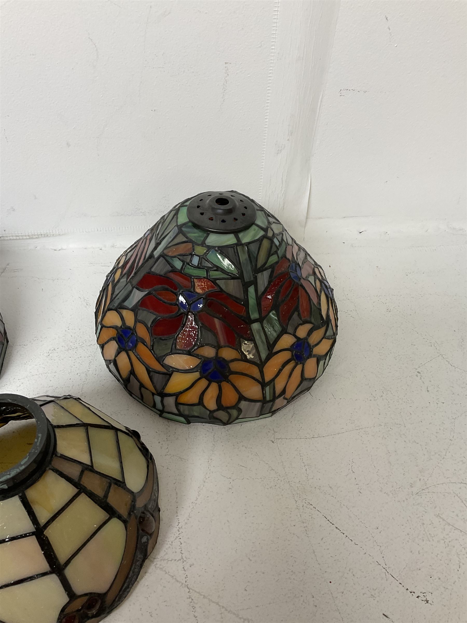 Three Tiffany style lamp shades, each with multicoloured floral decoration, largest D20.5cm