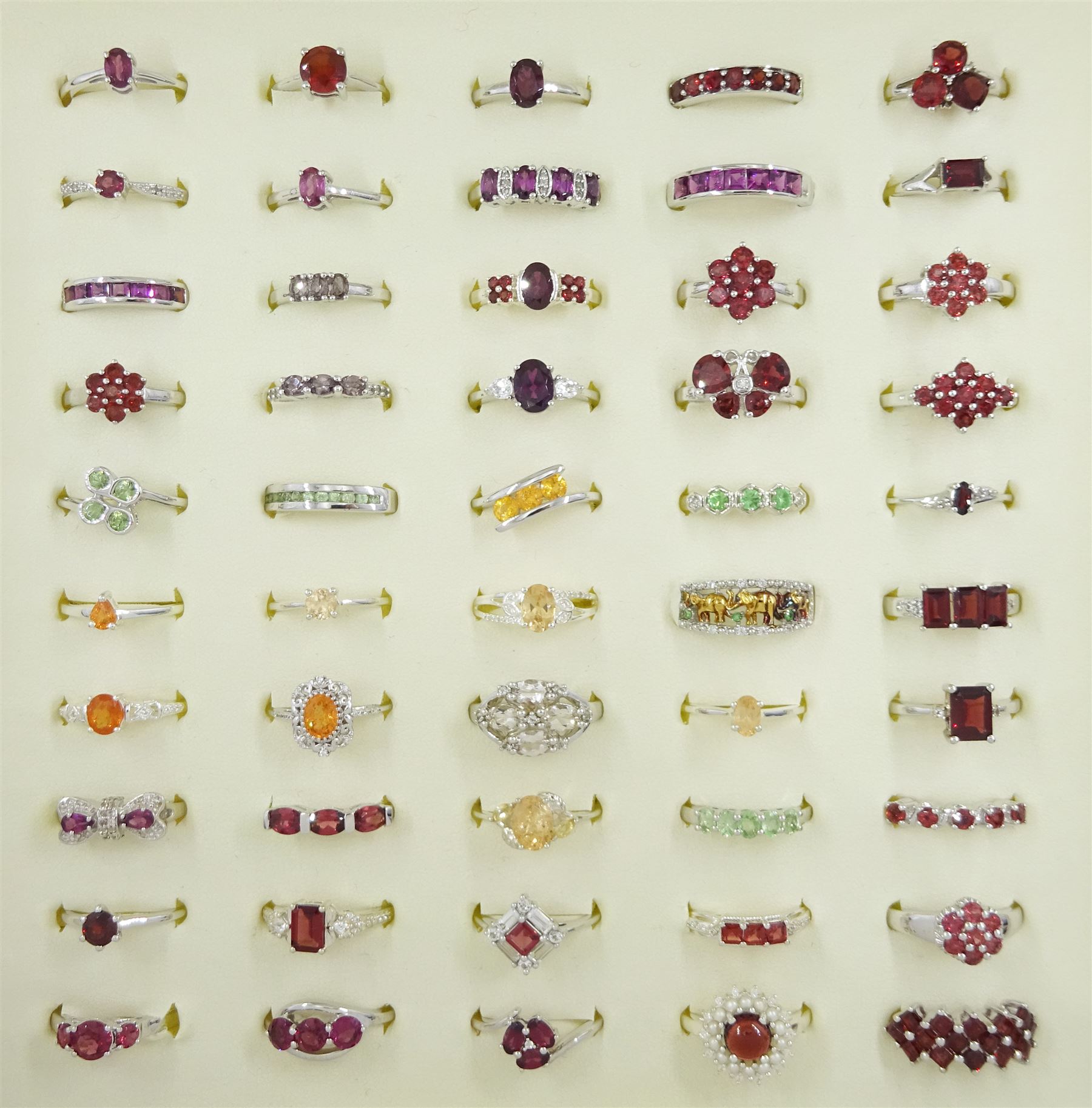 Fifty silver stone set rings including garnet, pearl, serenite and white zircon