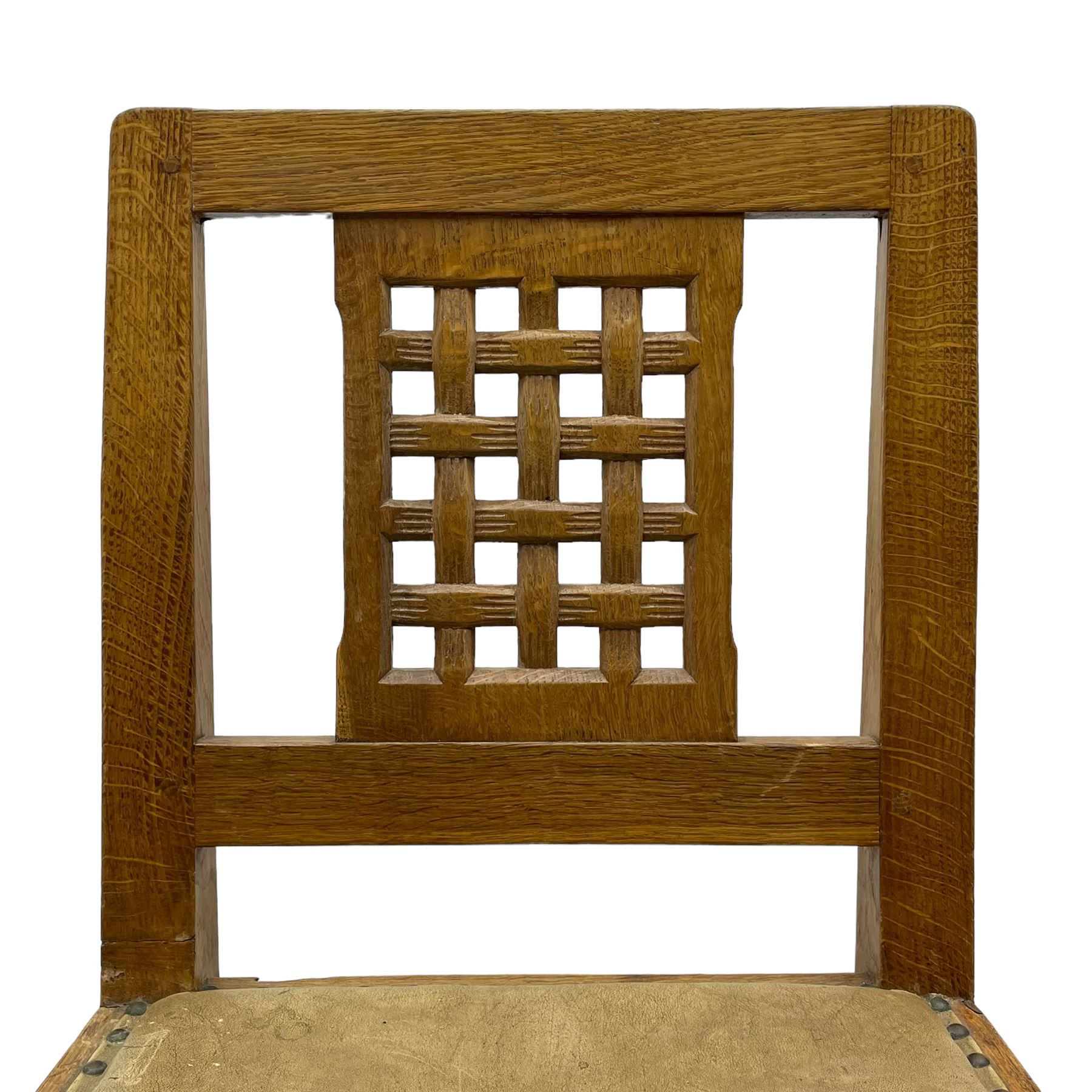 Rabbitman - set of six (5+1) oak dining chairs, pierced and carved lattice back, leather upholstered seat with stud band, on octagonal supports united by stretchers, carved with rabbit signature, by Peter Heap of Wetwang 