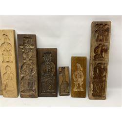 Collection of 20th century beech and other hardwood Dutch folk art Speculaasplank or biscuit moulds, most examples typically carved with figures in traditional dress, tallest H52cm