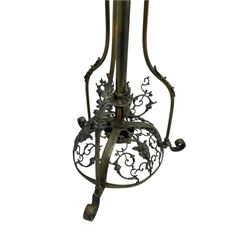 Victorian brass converted oil lamp stand, telescopic stem with scrolled uprights terminating to scrolled feet, dished base decorated with scrolling cast metal work and grotesque masks 