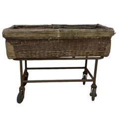 Early 20th century GPO wicker and hide bound postal trolley, on a cast iron base with castors