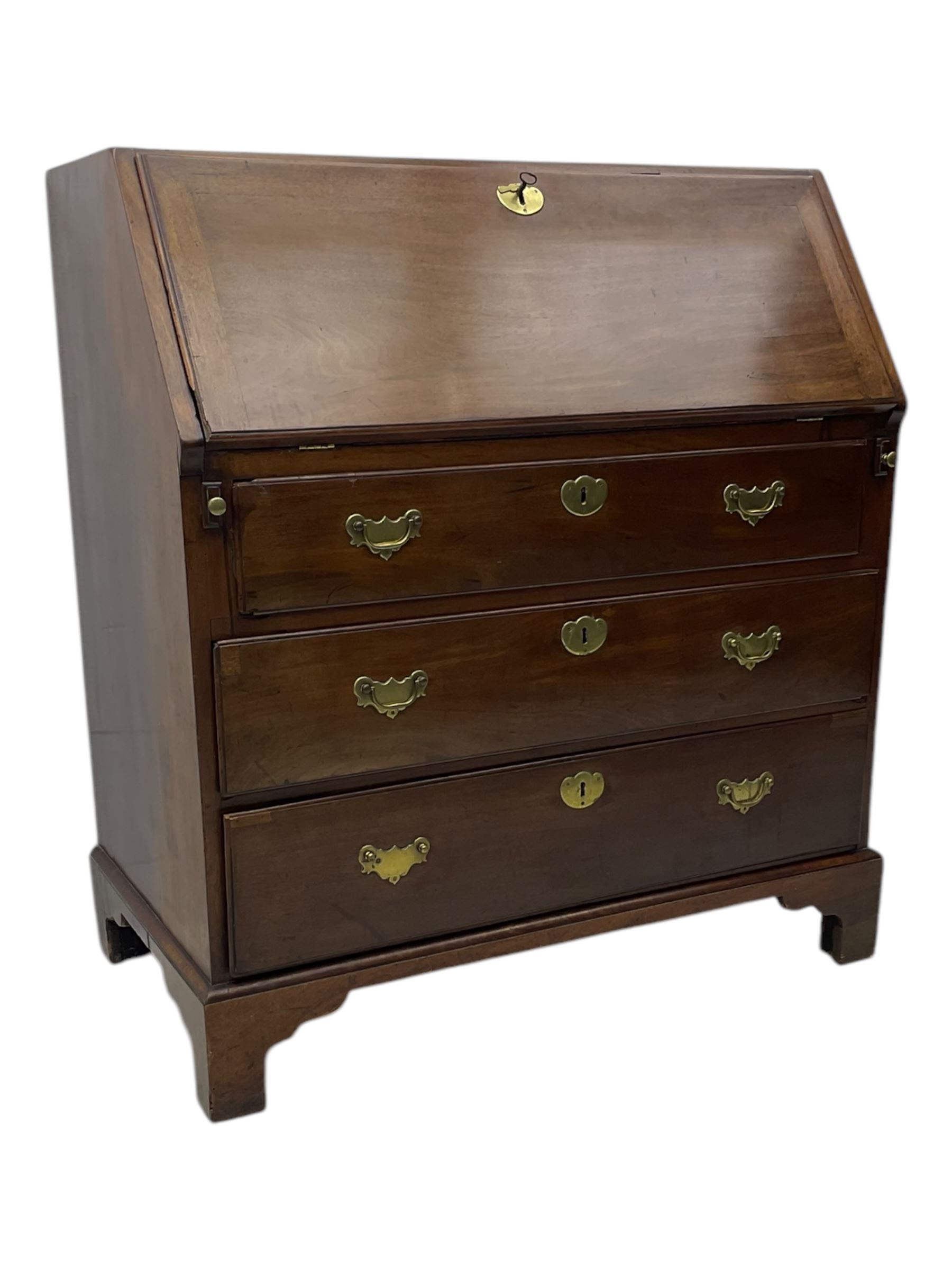 George III mahogany bureau, the fall front enclosing fitted interior, three graduating long drawers, on bracket feet