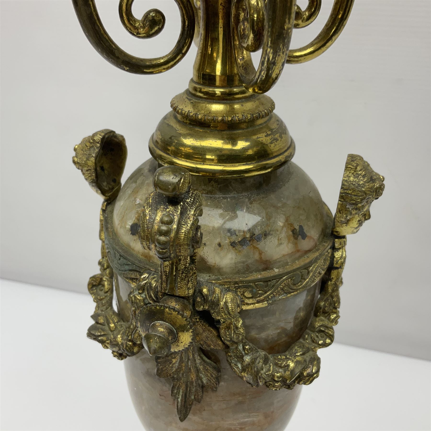 20th century five branch candelabra, with gilded floral garland and female mask decoration, to a marble effect resin urn and stepped base, upon four paw feet, H61cm