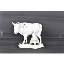 19th century Delft figure group depicting a milkmaid milking a cow, H17.7cm