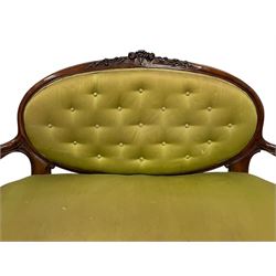 Victorian carved walnut framed two seat settee, cresting rail carved and moulded with a posy of roses and trailing foliate, over an oval back with scrolled arm terminals, serpentine fronted seat over cabriole supports with bell-flower carved knees, buttoned back and sprung seat upholstered in olive green fabric