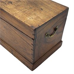 19th century teak blanket chest, hinged lid over plain front, fitted with brass carrying handles on plinth base 