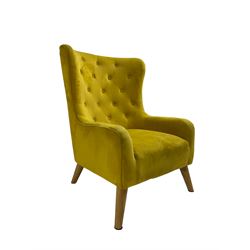 Mid-20th century design armchair, barrel back upholstered in buttoned mustard fabric, on tapering splayed front feet