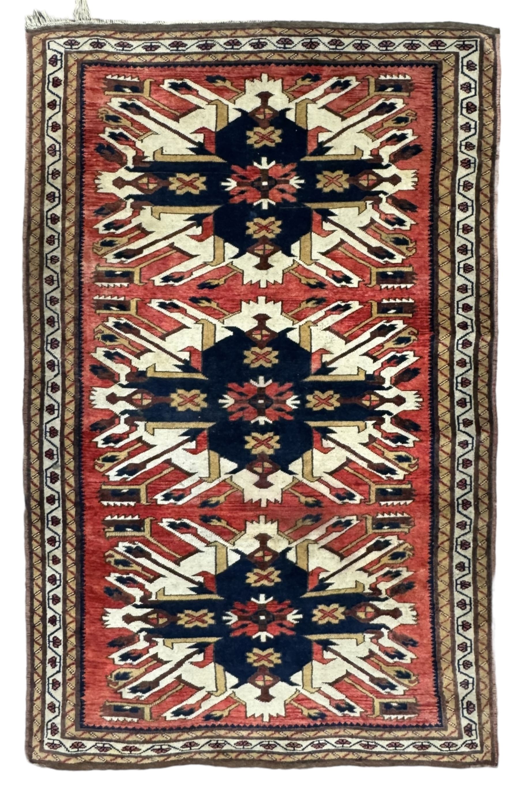 Persian Heriz red ground rug, the field with three large central medallions in indigo and ivory, border with geometric pattern within multiple guard stripes (119cm x 189cm); Persian Yomut crimson ground rug, central field with ivory medallion with geometric motifs, main border with geometric pattern within multiple guard stripes (88cm x 133cm)