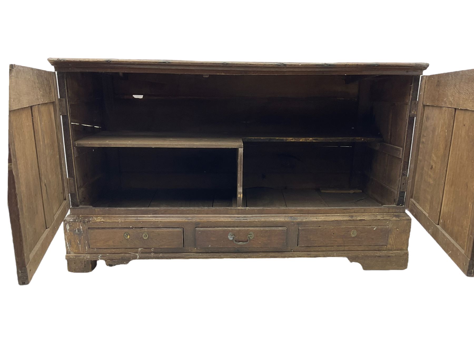 Georgian oak converted mule chest, rectangular plank top over two cupboards with arched Gothic motif panels enclosing storage area with shelves, the base with three drawers with pull handles, on shaped bracket feet