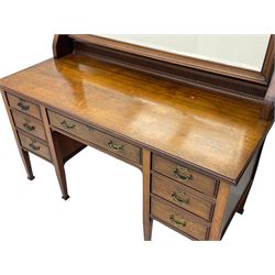 Late 19th century walnut dressing table, wide rectangular bevelled swing mirror in moulded frame, shaped horns carved with scrolls, moulded rectangular top over seven drawers, on square tapering supports with spade feet 