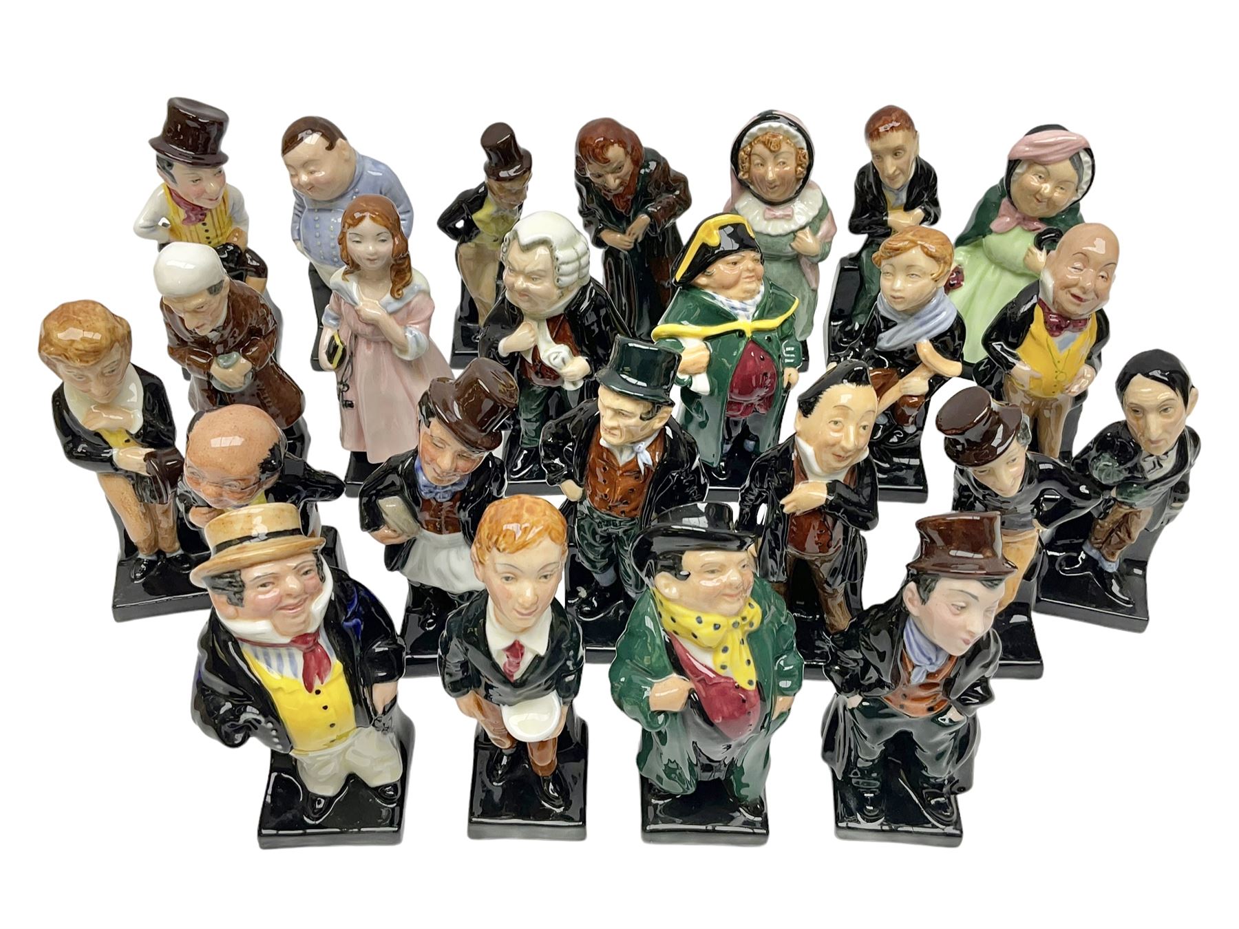 Twenty four Royal Doulton figures of characters from the works of Charles Dickens, to include Sam Weller, Pecksniff, Oliver Twist, Sairey Gamp, Artful dodger etc