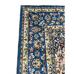 Persian Nain blue ground carpet, overall arabesque design, centre rosette medallion with eight projecting palmettes, the surrounding field decorated with interlacing branches and stylised plant motifs, within floral pale ground spandrels, the guarded border decorated with repeating stylised floral pattern 