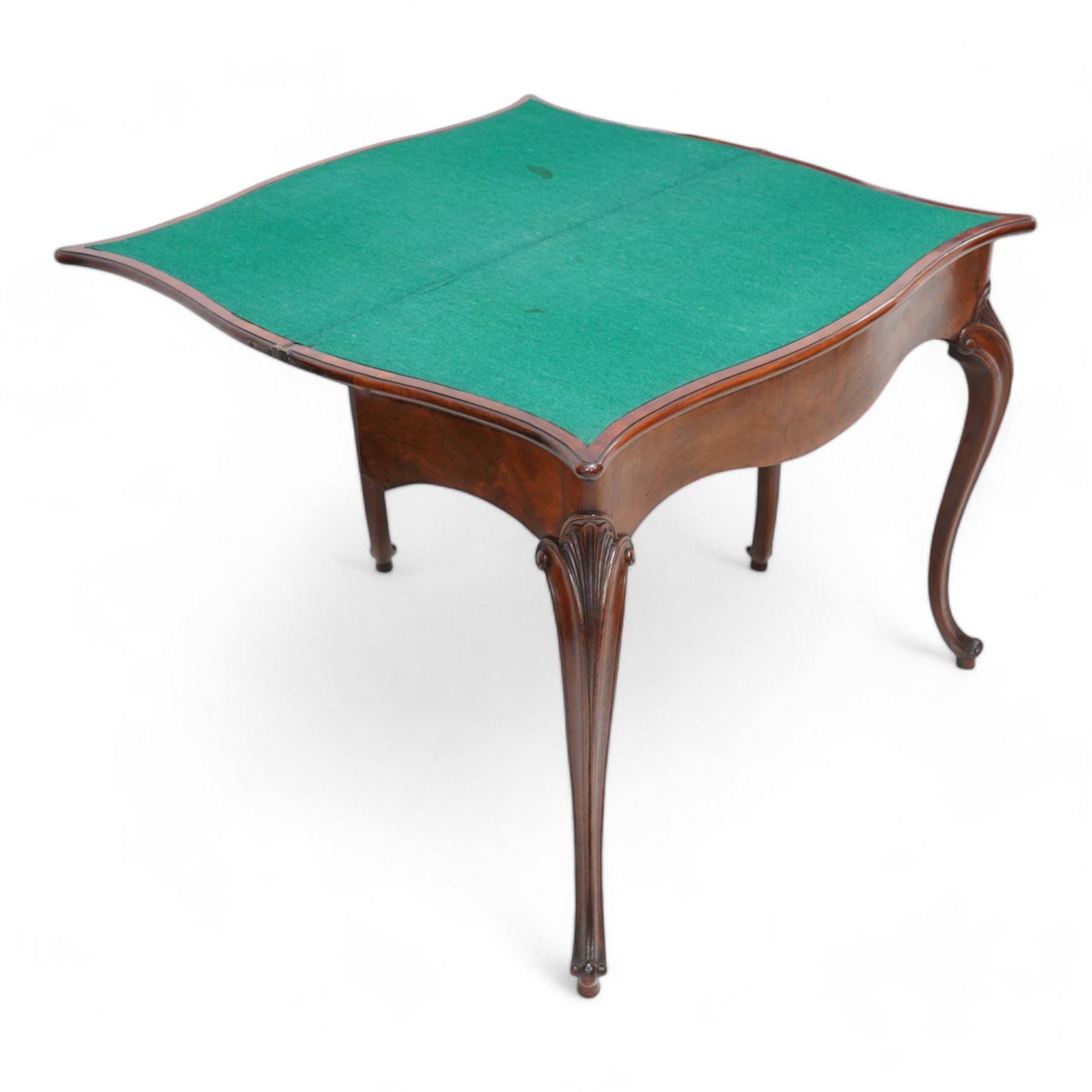 George III inlaid mahogany card table of serpentine form, the shaped rectangular fold-over top decorated with cross-banding and chequered inlay, opening to reveal a baize lined interior, the shaped apron over moulded cabriole supports with scroll and scallop carved knees, on scroll feet