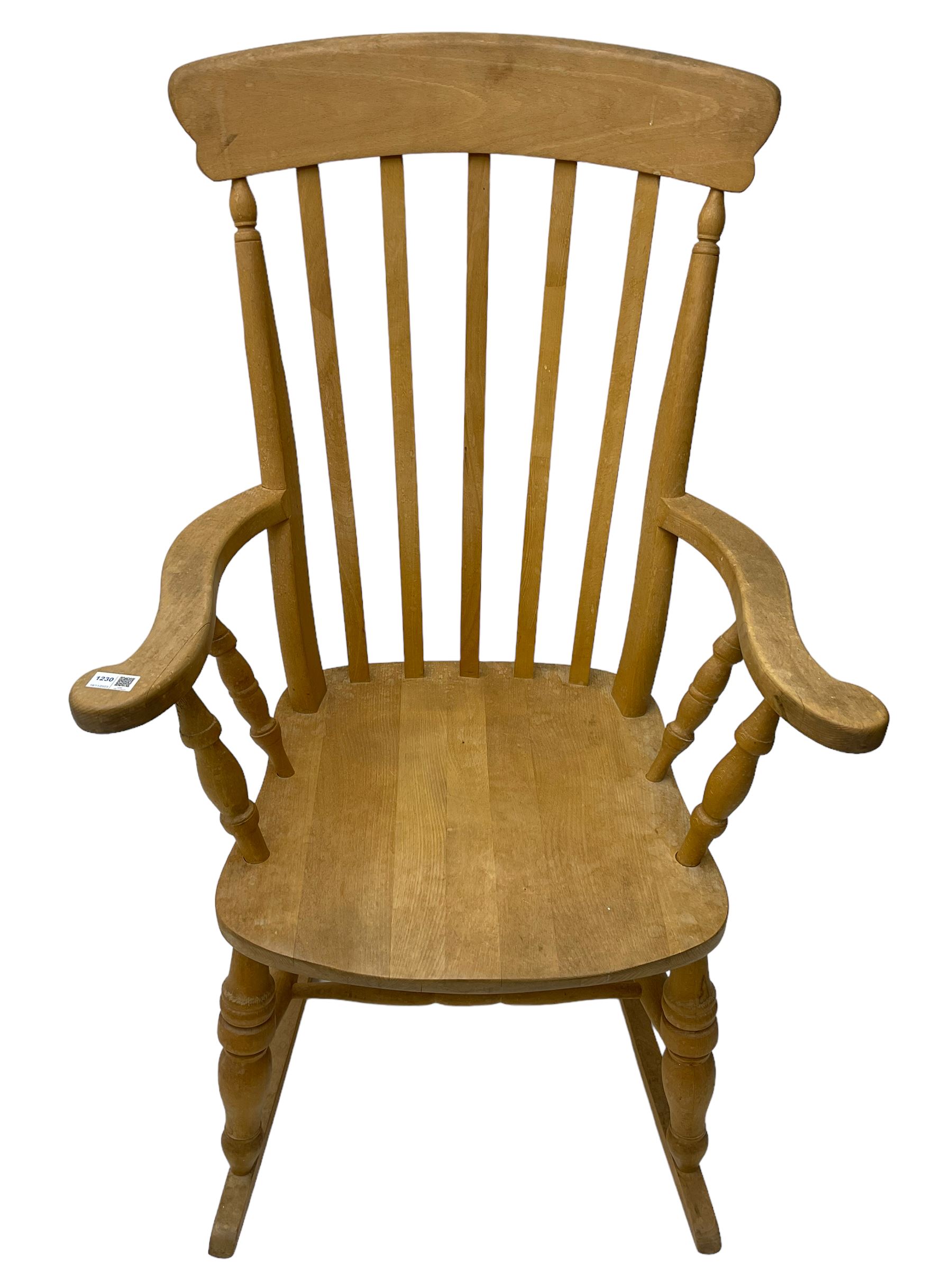 Farmhouse style beech rocking chair, shaped cresting rail on vertical slats, on turned front supports joined by swell-turned double H stretcher base