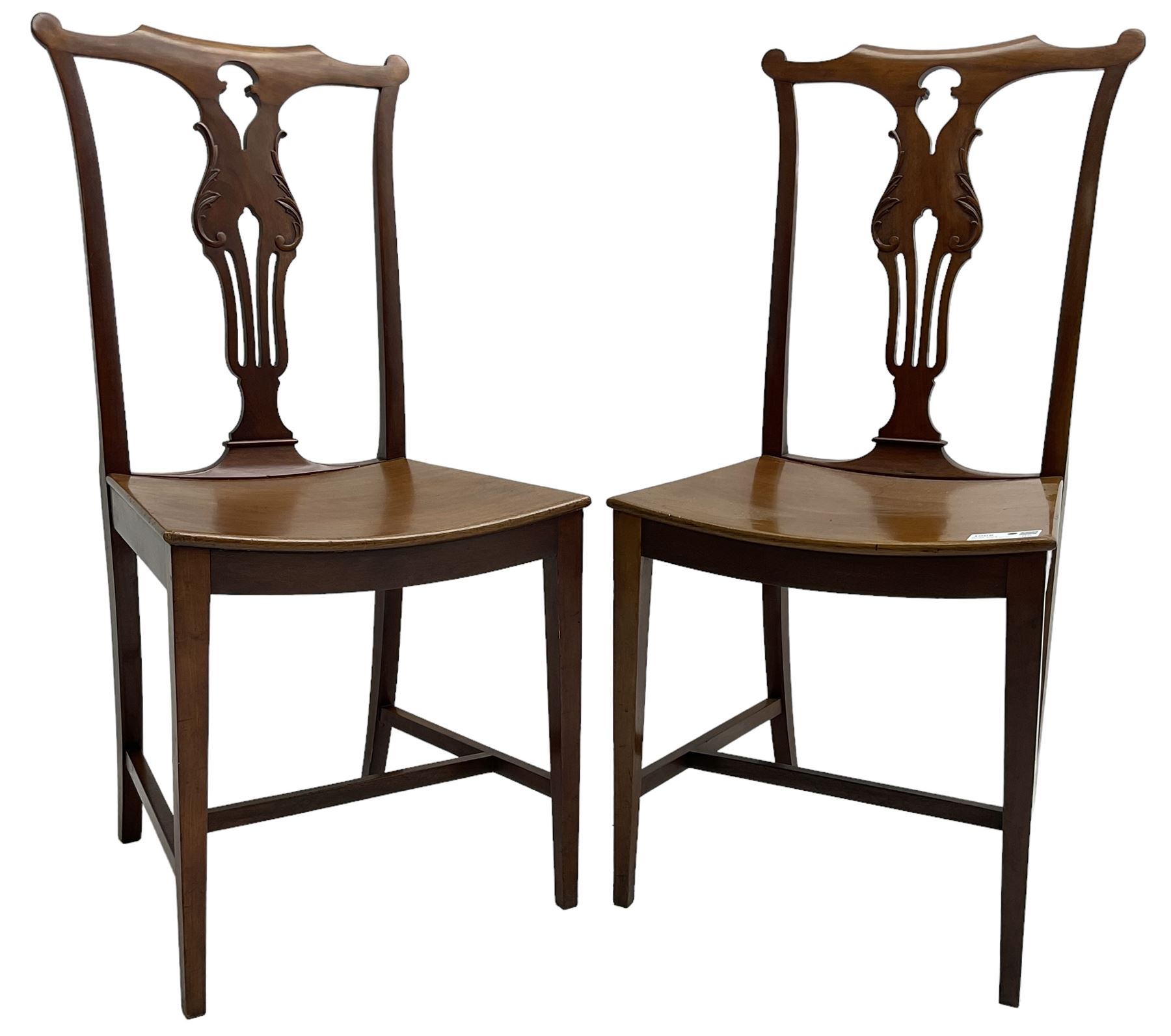 Early 20th century pair of mahogany side chairs, shaped cresting rail over shaped and pierced splat carved with curled leaf decoration, dished seat on square tapering supports united by H-stretchers 