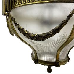 Edwardian brass ceiling light of circular bulbous form, moulded upper band over a guilloche cast central band united by shaped strapping, decorated with fruiting foliage festoons, fitted with frosted and vertical bevelled glass bowl, acanthus cast finial 