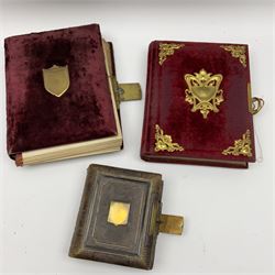 Three Victorian musical albums including one leather bound smaller example all with brass fixtures and interior gilt decoration bordering the apertures of portraits of various sizes and shapes, with boxed cylindrical movements