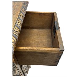 Victorian carved oak kneehole desk, the rectangular top with carved edge, above central drawer with carved front and brass handles, central kneehole with cupboard door, flanked by two banks of three graduating drawers each with similarly carved decoration, on shaped plinth base with castors