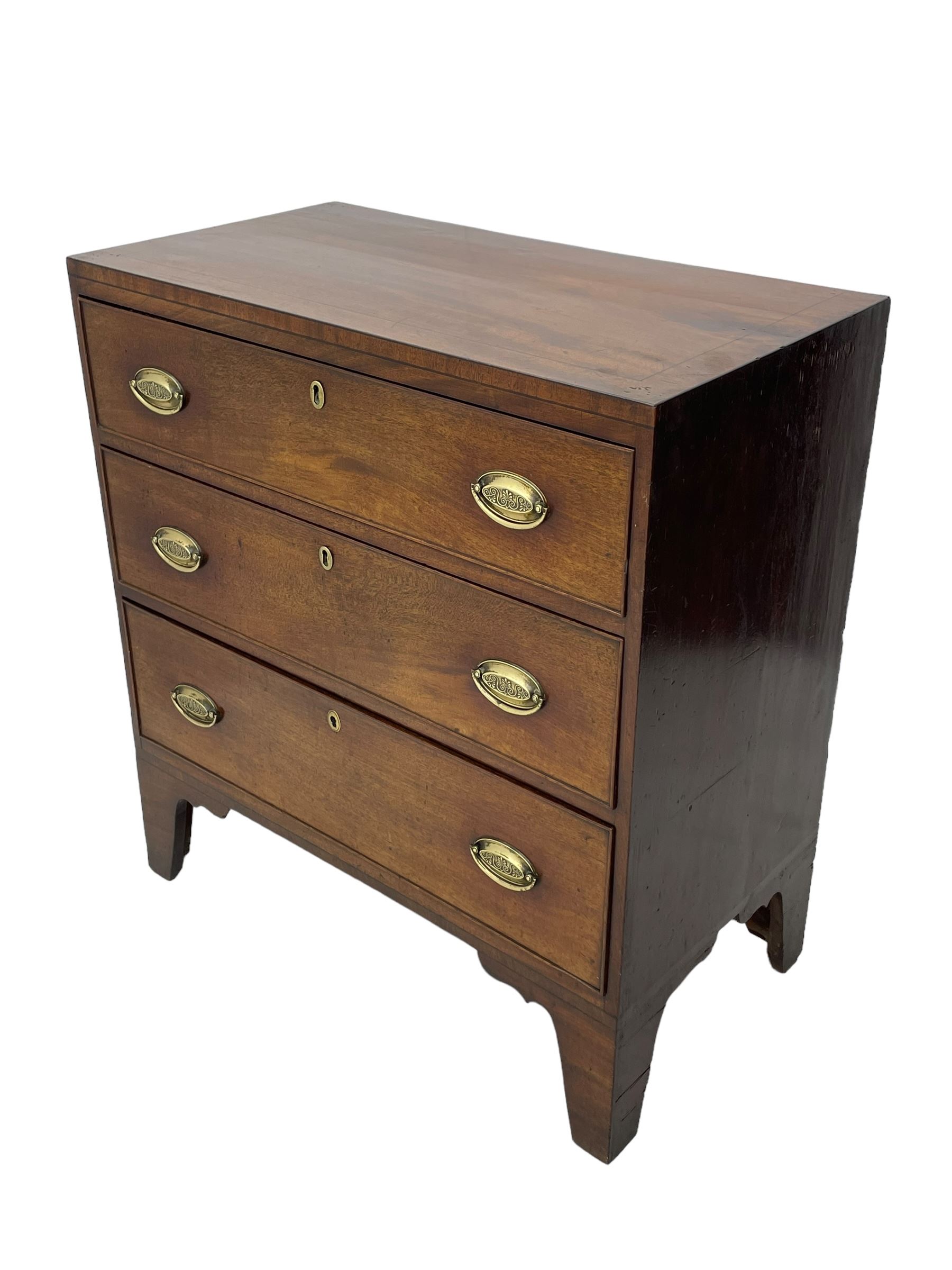 George III mahogany chest, rectangular ebony strung top, fitted with three graduating cock-beaded drawers with oval pressed brass handle plates and demi-lune handles, on tall bracket feet 