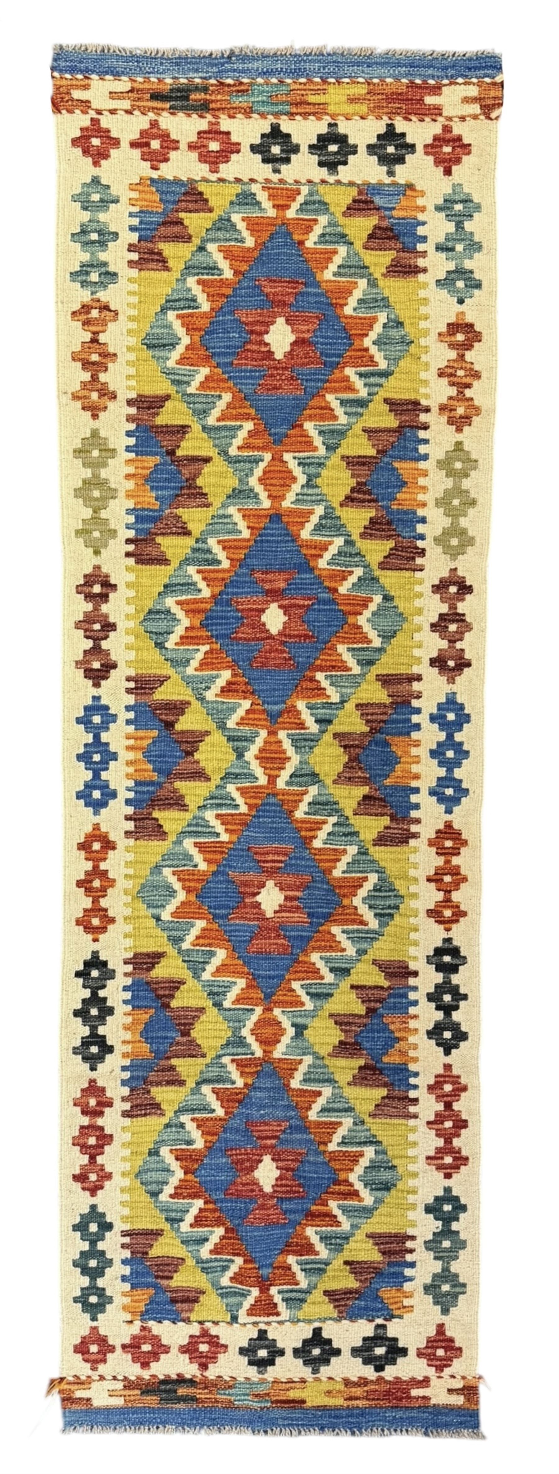 Kilim runner rug, central field decorated with four stacked geometric medallions in a multicoloured zigzag design, bordered by a series of small geometric motifs, fringed edges at both ends