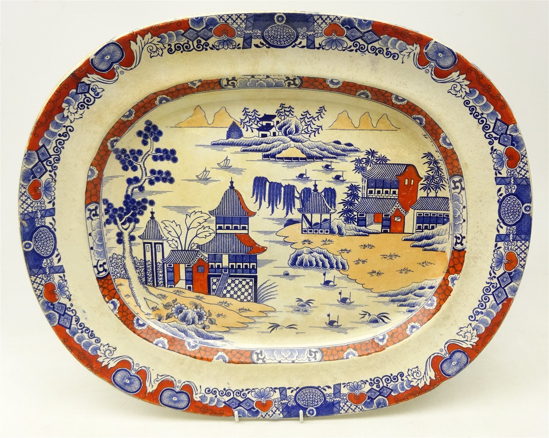 19th century Masons Ironstone china meat plate decorated with pagodas within a river landscape, with underglaze blue and iron red painted decoration, L49cm