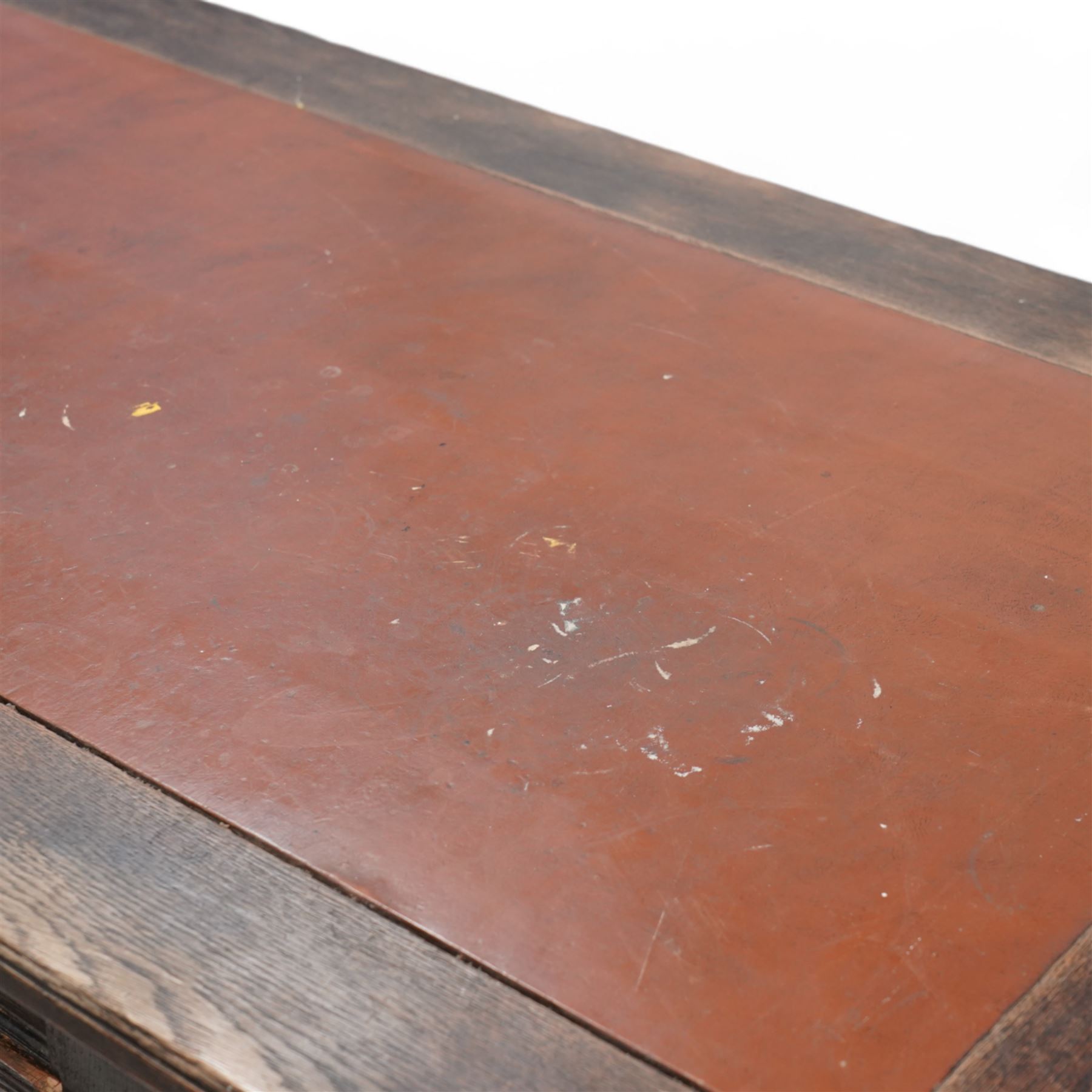 Late Victorian oak twin pedestal desk, rectangular moulded top with brown leather inset, three drawers fitted with Aesthetic Movement angular handles, each pedestal enclosed by door with turned columns, on moulded plinth base 