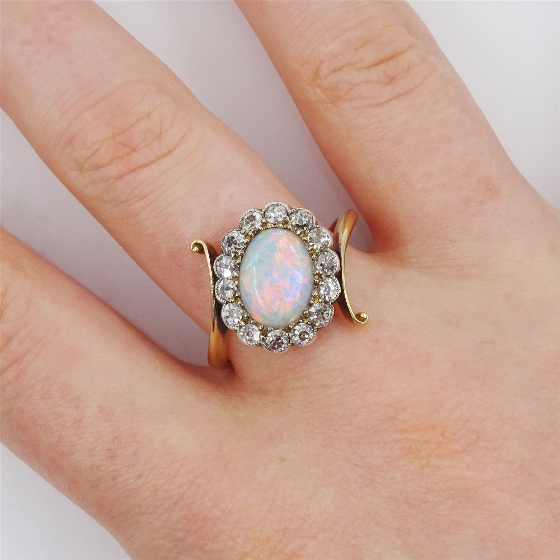 Early 20th century gold opal and milgrain set old cut diamond cluster ring, with twist scroll shoulders, stamped 18ct, total diamond weight approx 0.55 carat