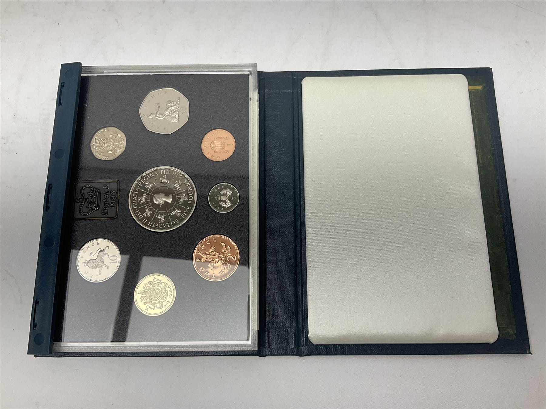 Ten The Royal Mint United Kingdom proof coin collections, dated 1983, 1984, 1985, 1986, 1987, 1992, 1994, two 1997 and 1998 all in blue folders with certificates