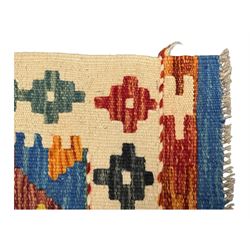 Kilim runner rug, central field decorated with four stacked geometric medallions in a multicoloured zigzag design, bordered by a series of small geometric motifs, fringed edges at both ends