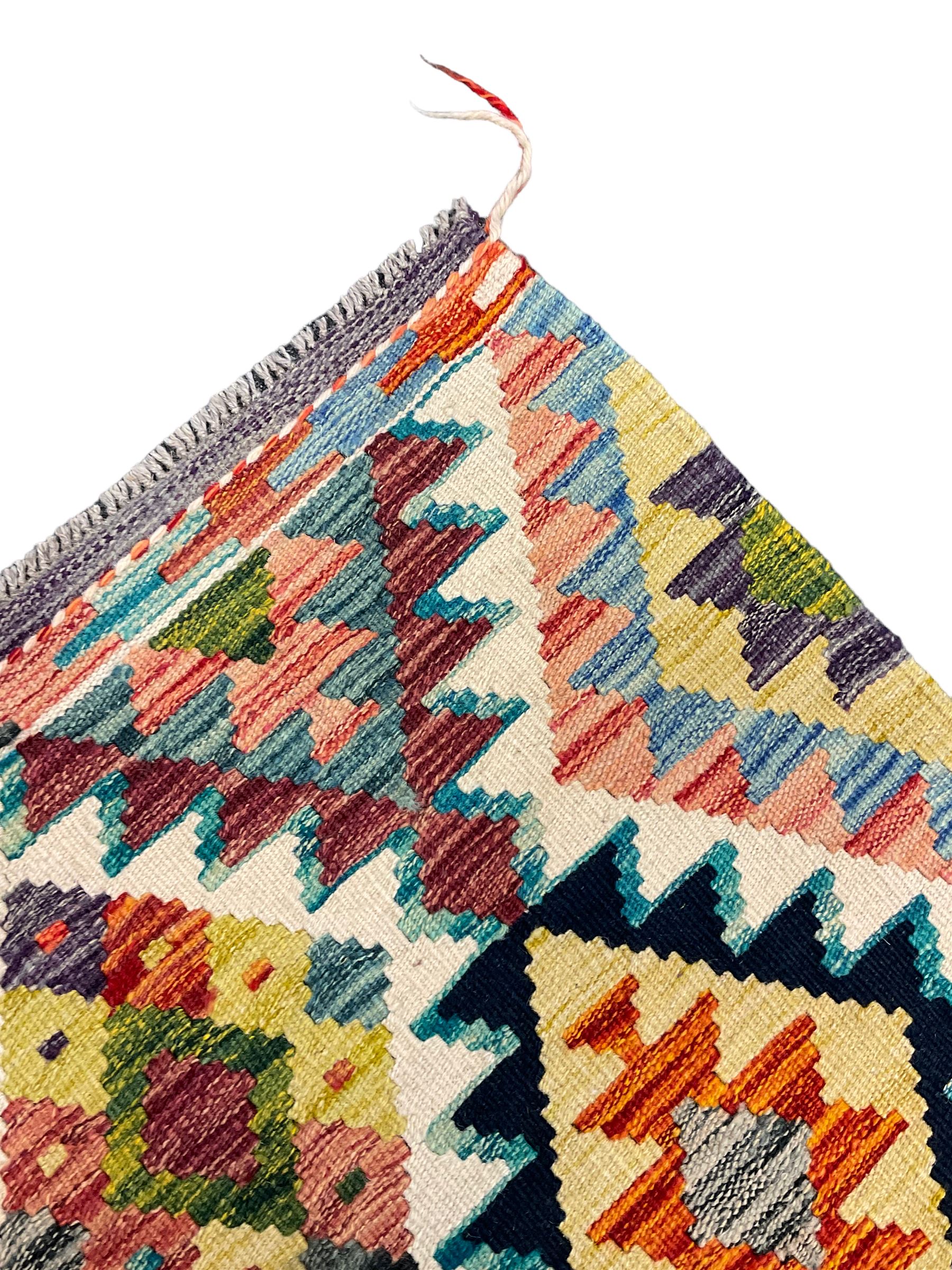 Chobi Kilim rug, over geometric design, decorated with multi-coloured stepped lozenges