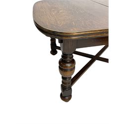 Early 20th century oak extending dining table, rectangular top with rounded corners, on turned baluster supports united by X-stretchers, fitted with a pull-out extending mechanism (106 x 142 - 228cm, H76cm); set of eight high-back dining chairs upholstered in green fabric with geometric diamond pattern