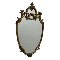 Mid-20th century Italian giltwood mirror, shaped frame with pierced floral and foliate dec...