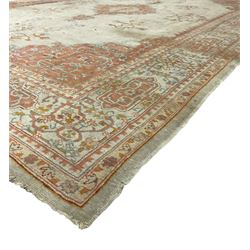 Large Persian pale sage ground carpet, the field decorated with central geometric medallion and tree of life motifs, the border with repeating geometric design decorated with stylised plant motifs