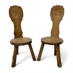 Gnomeman - two oak spinning or hall chairs, shaped splat backs, one carved with Yorkshire Rose, the other with mythical dragon, decagon seats on chamfered square tapering supports, each carved with gnome signature, by Thomas Whittaker, Littlebeck