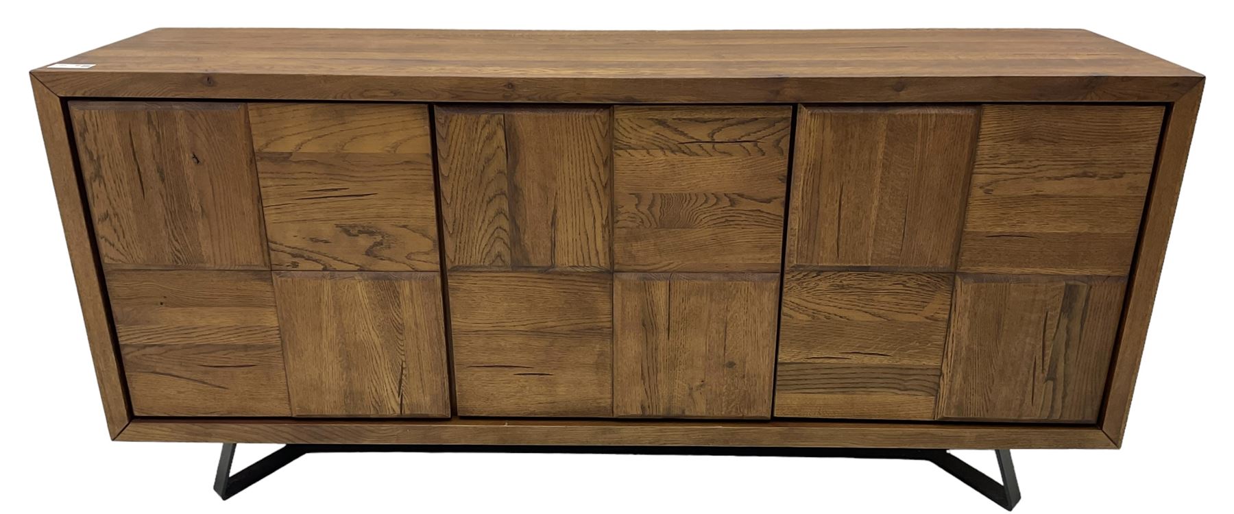 Samba 'Camden' oak sideboard, rectangular top over three block panelled cupboard doors, raised on angled black metal supports connected with stretcher