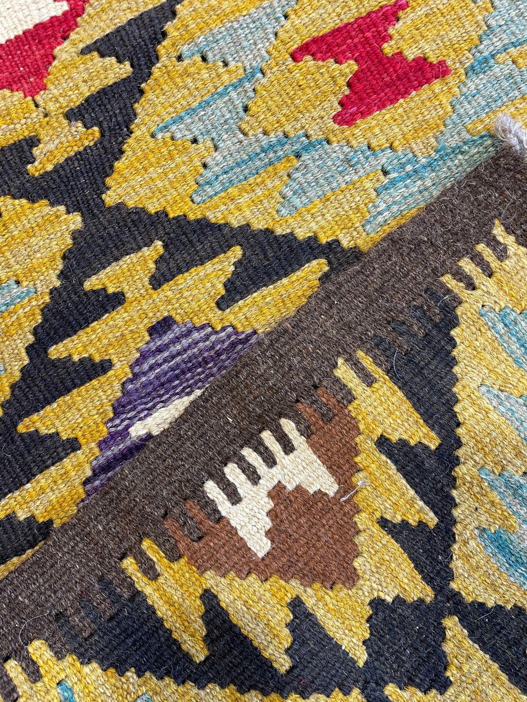 Chobi Kilim multi-colour runner rug, the field decorated with geometric lozenges in contrasting shades on brown ground