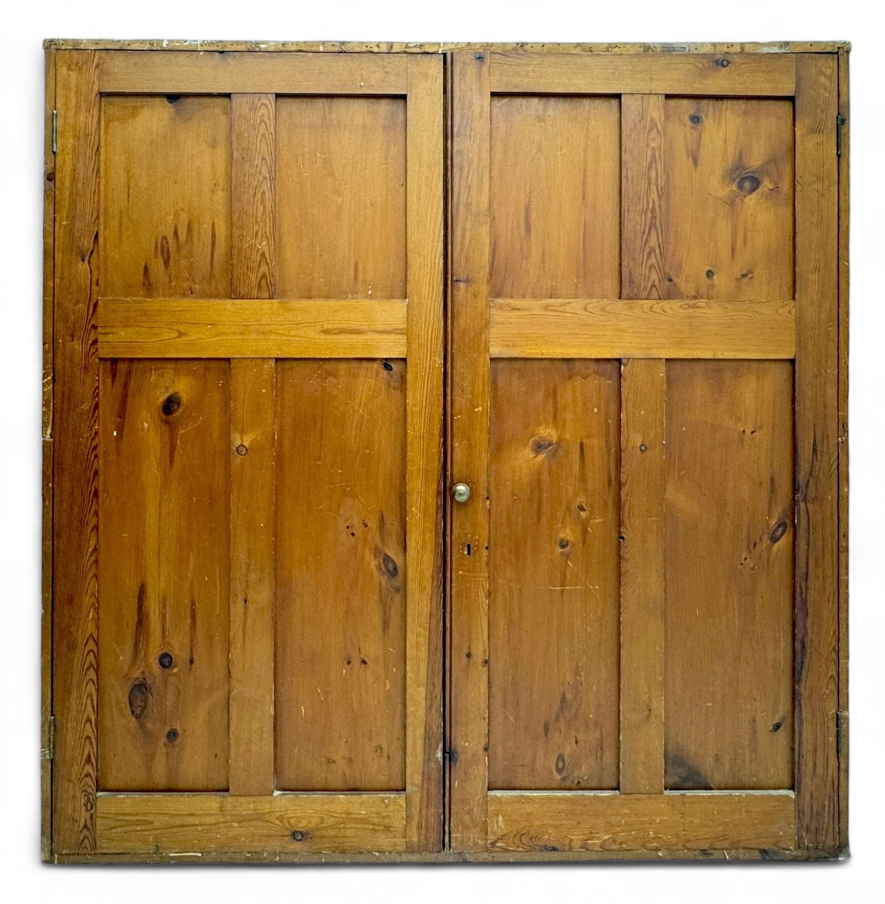 Large 19th century pine cupboard, rectangular top over two panelled later doors, enclosing four open shelves, on plinth base